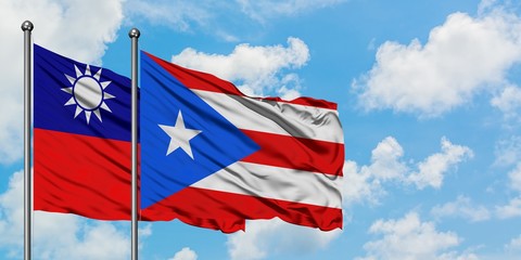 Taiwan and Puerto Rico flag waving in the wind against white cloudy blue sky together. Diplomacy concept, international relations.