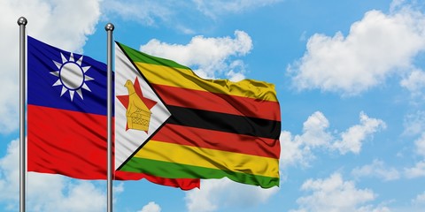 Taiwan and Zimbabwe flag waving in the wind against white cloudy blue sky together. Diplomacy concept, international relations.