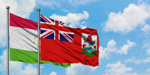 Tajikistan and Bermuda flag waving in the wind against white cloudy blue sky together. Diplomacy concept, international relations.