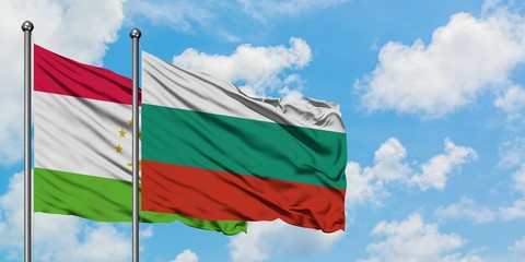Tajikistan and Bulgaria flag waving in the wind against white cloudy blue sky together. Diplomacy concept, international relations.