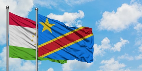 Tajikistan and Congo flag waving in the wind against white cloudy blue sky together. Diplomacy concept, international relations.