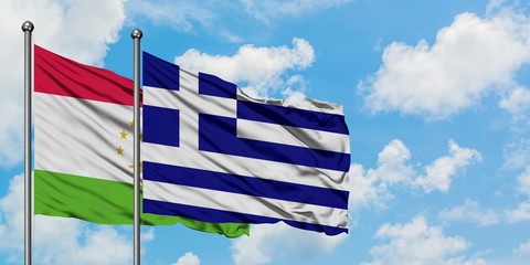 Tajikistan and Greece flag waving in the wind against white cloudy blue sky together. Diplomacy concept, international relations.