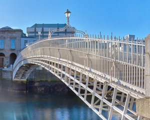 Half penny bridge, also called Ha'penny bridge,on a bridht day under blue sky in Dublin