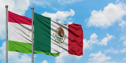 Tajikistan and Mexico flag waving in the wind against white cloudy blue sky together. Diplomacy concept, international relations.