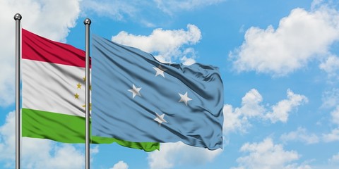 Tajikistan and Micronesia flag waving in the wind against white cloudy blue sky together. Diplomacy concept, international relations.