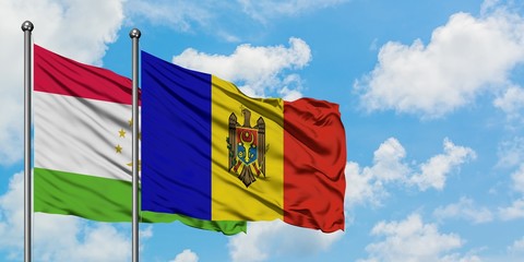 Tajikistan and Moldova flag waving in the wind against white cloudy blue sky together. Diplomacy concept, international relations.