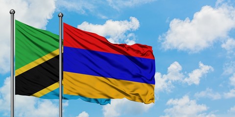 Tanzania and Armenia flag waving in the wind against white cloudy blue sky together. Diplomacy concept, international relations.