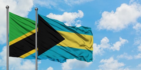 Fototapeta premium Tanzania and Bahamas flag waving in the wind against white cloudy blue sky together. Diplomacy concept, international relations.