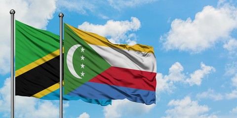 Tanzania and Comoros flag waving in the wind against white cloudy blue sky together. Diplomacy concept, international relations.