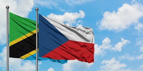 Tanzania and Czech Republic flag waving in the wind against white cloudy blue sky together. Diplomacy concept, international relations.