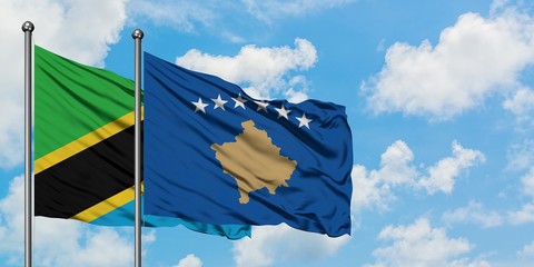 Tanzania and Kosovo flag waving in the wind against white cloudy blue sky together. Diplomacy concept, international relations.