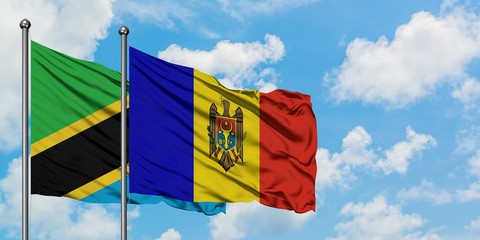 Tanzania and Moldova flag waving in the wind against white cloudy blue sky together. Diplomacy concept, international relations.