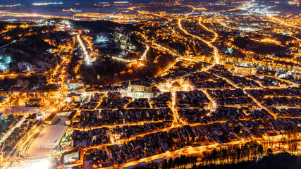 Brasov, Transylvania. Romania. Panoramic view at night of the old town and Council Square, Aerial twilight cityscape of Brasov city, Romania