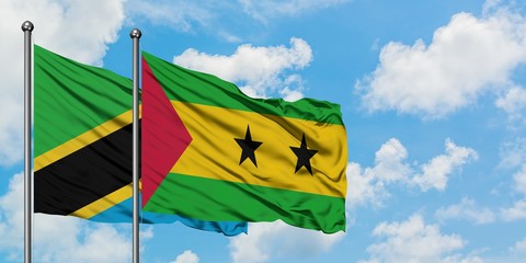 Tanzania and Sao Tome And Principe flag waving in the wind against white cloudy blue sky together. Diplomacy concept, international relations.