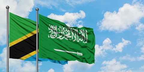 Tanzania and Saudi Arabia flag waving in the wind against white cloudy blue sky together. Diplomacy concept, international relations.