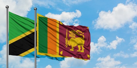 Tanzania and Sri Lanka flag waving in the wind against white cloudy blue sky together. Diplomacy concept, international relations.