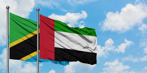 Tanzania and United Arab Emirates flag waving in the wind against white cloudy blue sky together. Diplomacy concept, international relations.