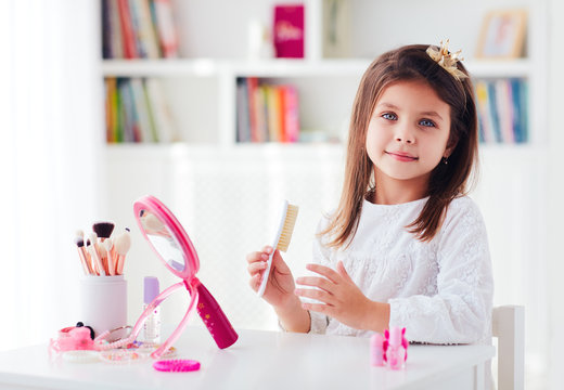 Beautiful Young Girl, Kid Brushing The Hair, Applying Makeup With Toy Beauty Set