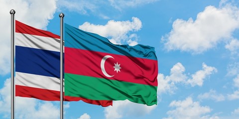 Thailand and Azerbaijan flag waving in the wind against white cloudy blue sky together. Diplomacy concept, international relations.