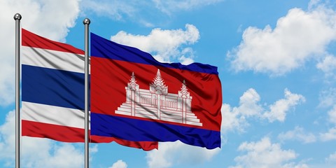 Thailand and Cambodia flag waving in the wind against white cloudy blue sky together. Diplomacy concept, international relations.