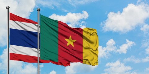 Thailand and Cameroon flag waving in the wind against white cloudy blue sky together. Diplomacy concept, international relations.