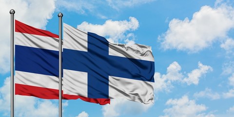 Thailand and Finland flag waving in the wind against white cloudy blue sky together. Diplomacy concept, international relations.