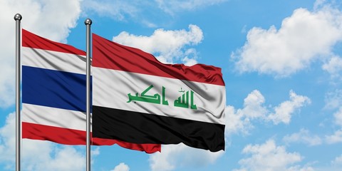 Fototapeta na wymiar Thailand and Iraq flag waving in the wind against white cloudy blue sky together. Diplomacy concept, international relations.