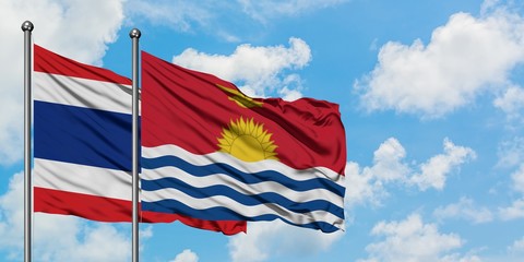 Thailand and Kiribati flag waving in the wind against white cloudy blue sky together. Diplomacy concept, international relations.