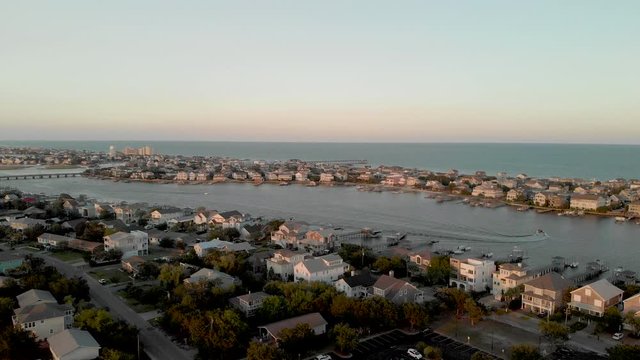 Aerial coastal housing during sunset 4K