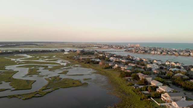 Sunset over coastal housing Aerial 4K