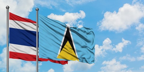 Thailand and Saint Lucia flag waving in the wind against white cloudy blue sky together. Diplomacy concept, international relations.