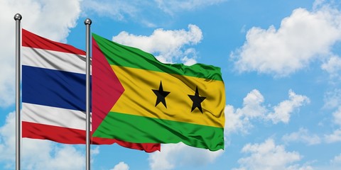 Thailand and Sao Tome And Principe flag waving in the wind against white cloudy blue sky together. Diplomacy concept, international relations.