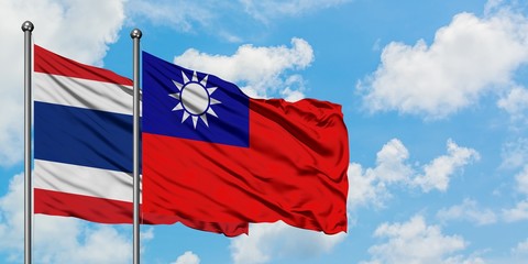 Fototapeta na wymiar Thailand and Taiwan flag waving in the wind against white cloudy blue sky together. Diplomacy concept, international relations.
