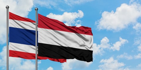 Thailand and Yemen flag waving in the wind against white cloudy blue sky together. Diplomacy concept, international relations.