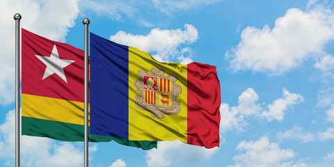 Togo and Andorra flag waving in the wind against white cloudy blue sky together. Diplomacy concept, international relations.