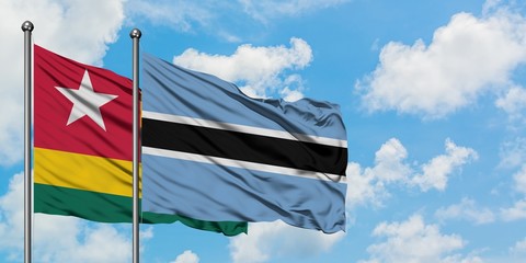 Togo and Botswana flag waving in the wind against white cloudy blue sky together. Diplomacy concept, international relations.