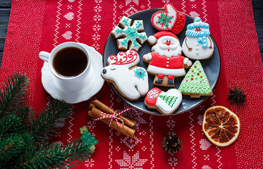 Homemade gingerbreads on plate on wooden background. Holidays and celebration concept, greeting card mockup, festive decoration. Christmas and New Year composition.