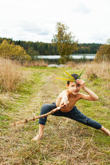 little cute boy playing outside like wild indian chief, lifestyle real people concept