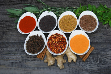 assortment of hearbs and spices on rustic wood