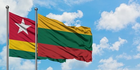 Togo and Lithuania flag waving in the wind against white cloudy blue sky together. Diplomacy concept, international relations.