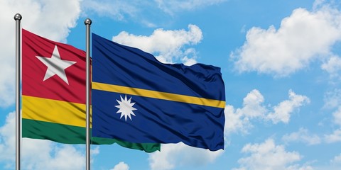 Togo and Nauru flag waving in the wind against white cloudy blue sky together. Diplomacy concept, international relations.
