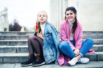 young happy students teenagers at university building on stairs, lifestyle people concept brunette and blond girl