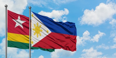 Togo and Philippines flag waving in the wind against white cloudy blue sky together. Diplomacy concept, international relations.