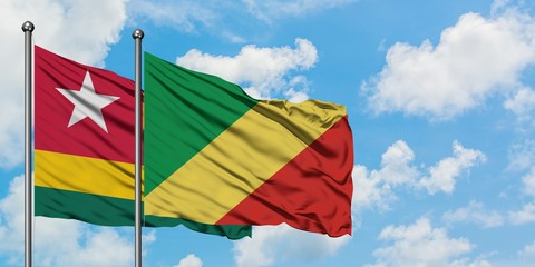 Togo and Republic Of The Congo flag waving in the wind against white cloudy blue sky together. Diplomacy concept, international relations.
