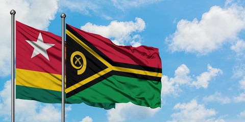 Togo and Vanuatu flag waving in the wind against white cloudy blue sky together. Diplomacy concept, international relations.