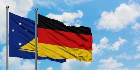 Tokelau and Germany flag waving in the wind against white cloudy blue sky together. Diplomacy concept, international relations.