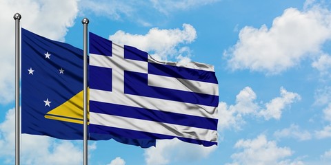 Tokelau and Greece flag waving in the wind against white cloudy blue sky together. Diplomacy concept, international relations.