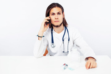 young male doctor with phone posing isolated on white background