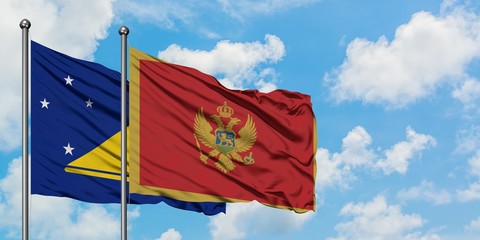 Tokelau and Montenegro flag waving in the wind against white cloudy blue sky together. Diplomacy concept, international relations.