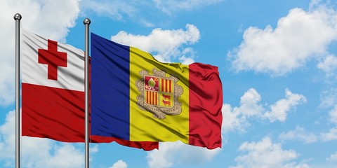 Tonga and Andorra flag waving in the wind against white cloudy blue sky together. Diplomacy concept, international relations.